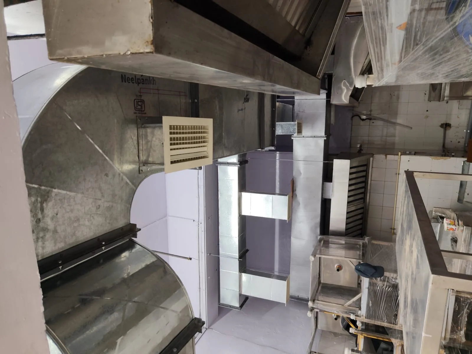 Fresh air duct run and supply grilles across a commercial kitchen ceiling