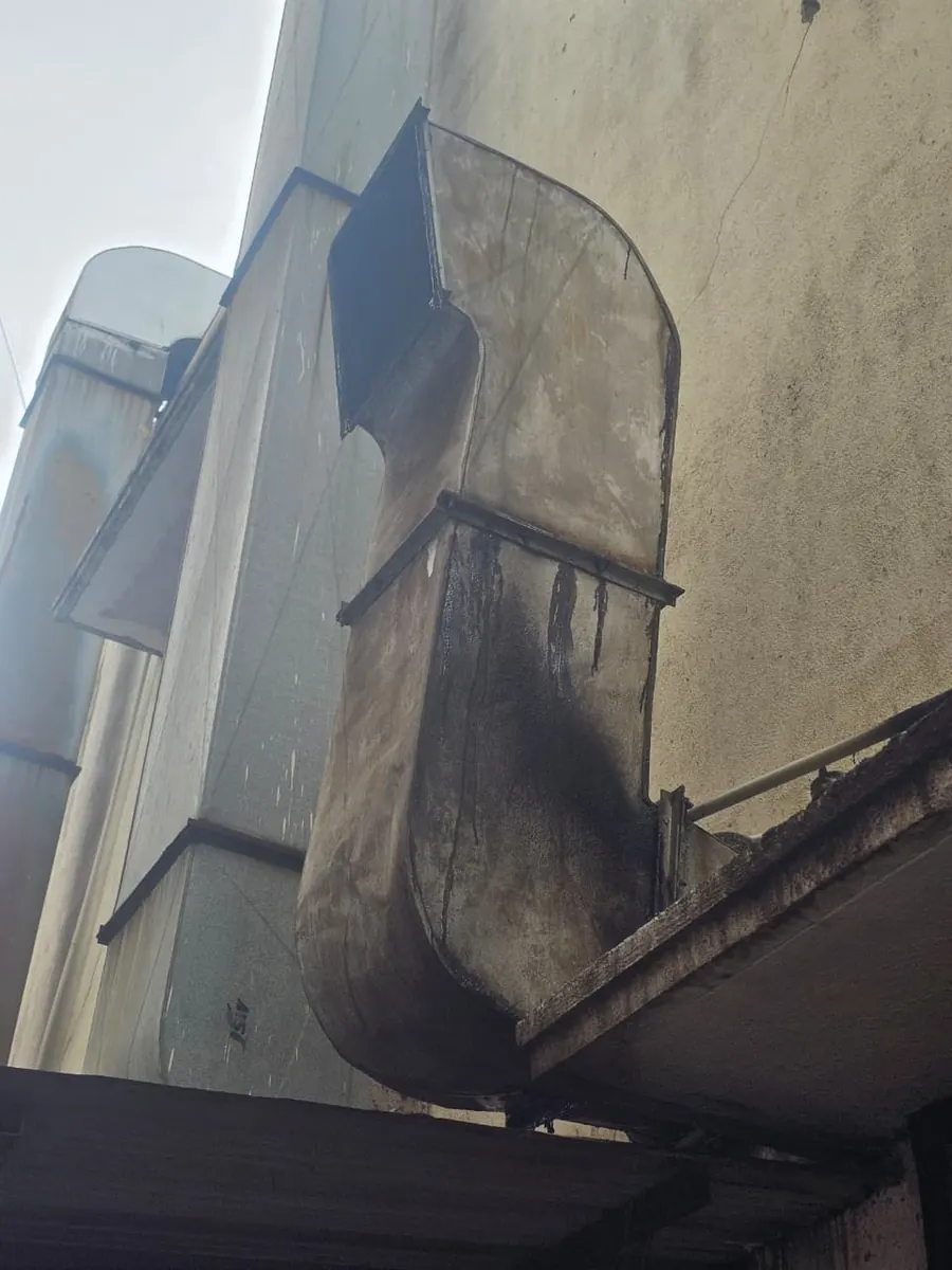 Galvanised duct riser and weather cowl running up an outside wall