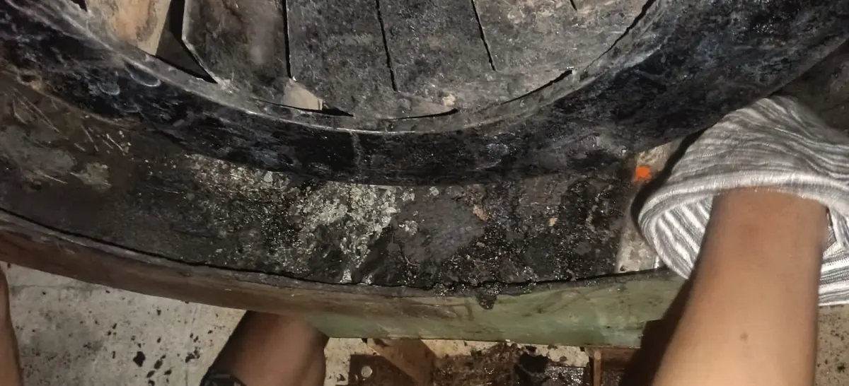 Grease being cleaned by hand from inside a fan housing