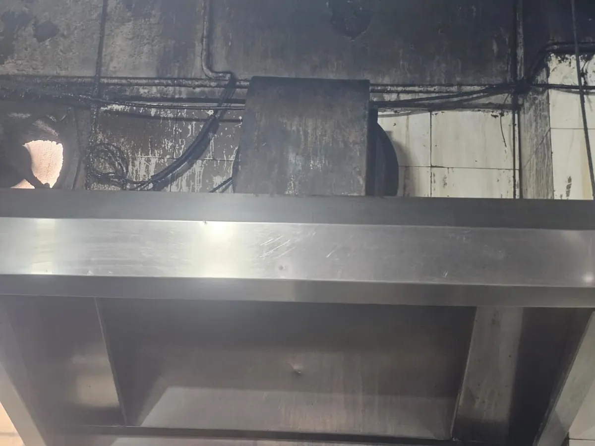 Stainless hood fitted directly over a commercial cooking range