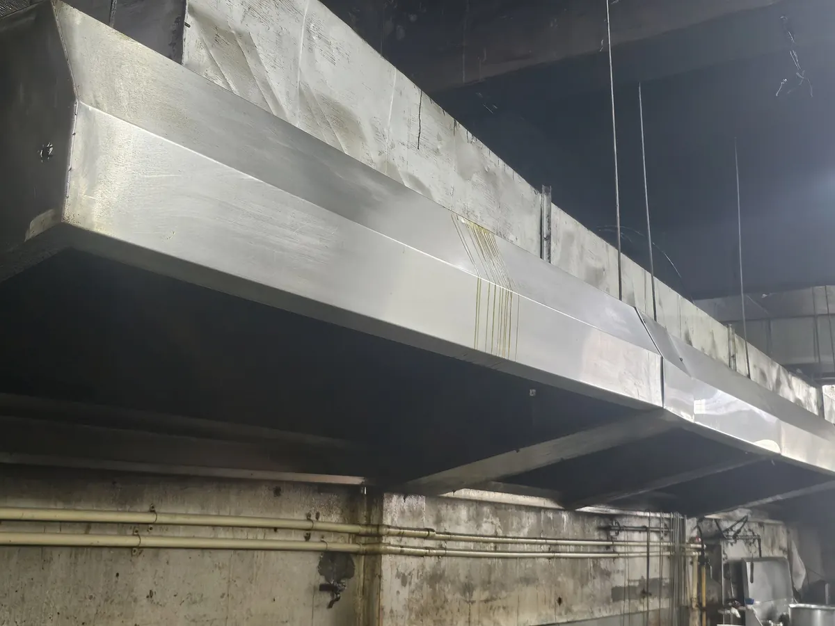 Full-length stainless hood and duct run after installation