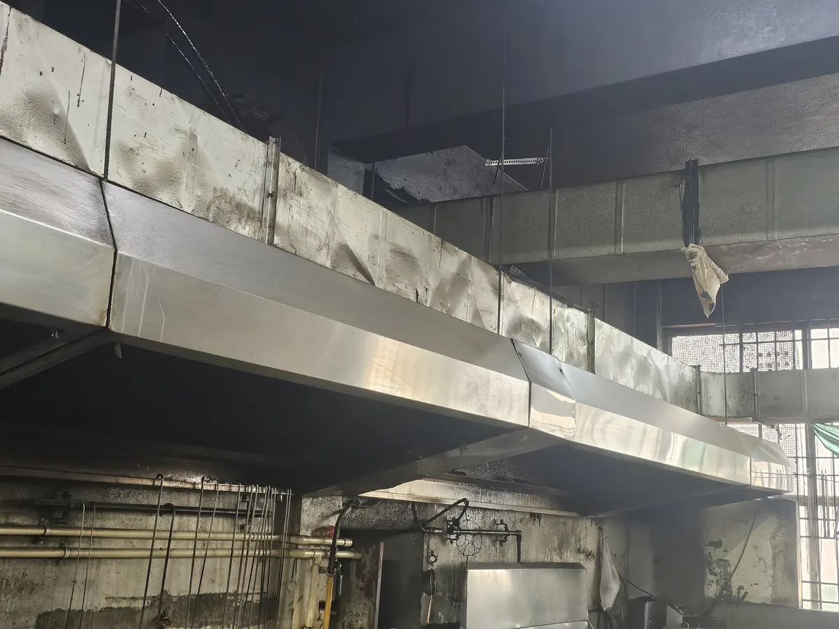 Hood and duct run installed along the length of a kitchen wall