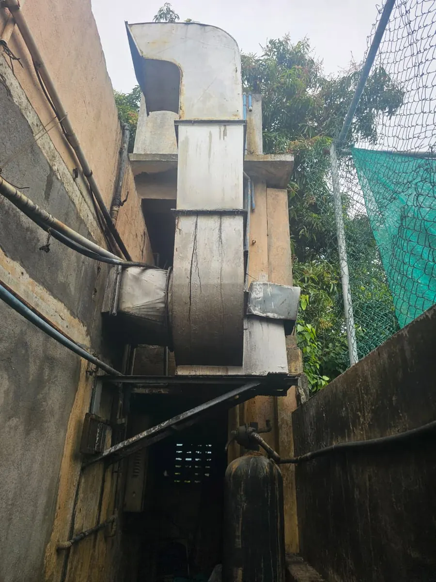 Exhaust duct carried down the outside of a compound wall