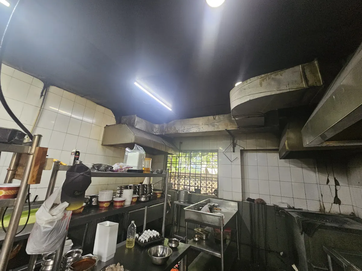 Completed hood installation above a busy working kitchen